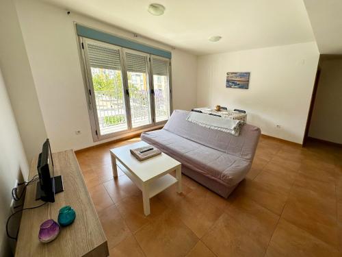 a living room with a couch and a table at Apartamentos Benicarló 3000 in Benicarló