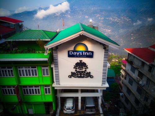 a building with a day inn sign on it at Days Inn by Wyndham Gangtok Tadong in Gangtok