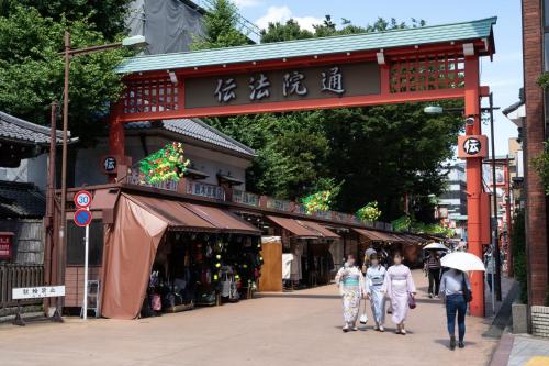 a group of people walking down a street at stayme THE HOTEL Asakusa Riverside in Tokyo