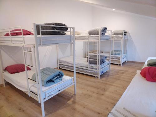 a group of bunk beds in a room at Les chambrées du bac in Charly-sur-Marne