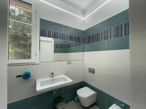 a bathroom with a sink and a toilet at Residence Bandiera Blu in Diamante