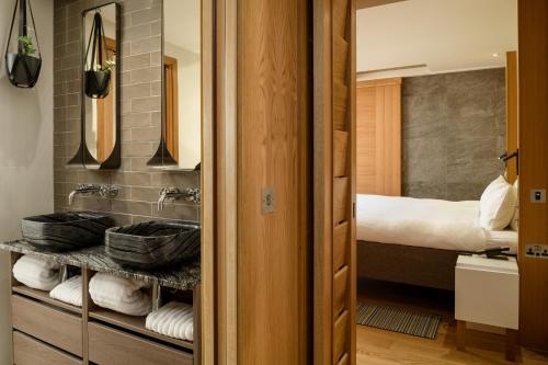 a bathroom with a sink and a bed in a room at Market Street hotel in Edinburgh