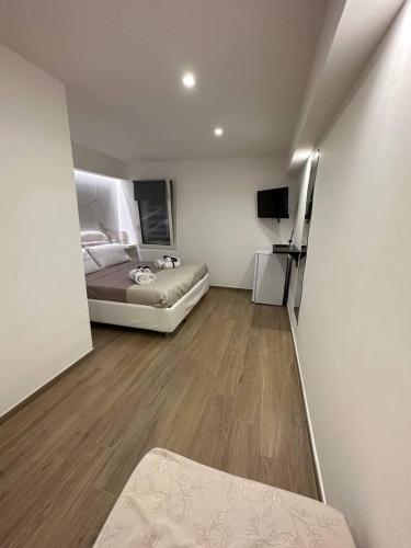 a bedroom with a bed and a television in it at Black & White Rooms in Bari