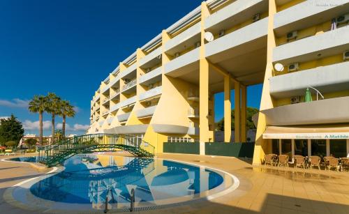 a building with a swimming pool in front of a building at Beach Way Apartment in Lagos