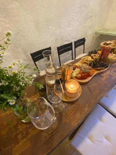 a table with wine glasses and food on it at Pura Vida Vrbice in Vrbice