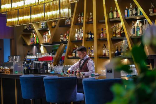 a man sitting at a bar in a restaurant at The Arkin Iskele in Iskele