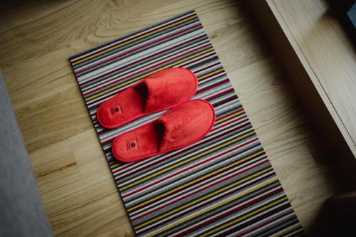 a pair of red shoes sitting on a rug at Market Street hotel in Edinburgh