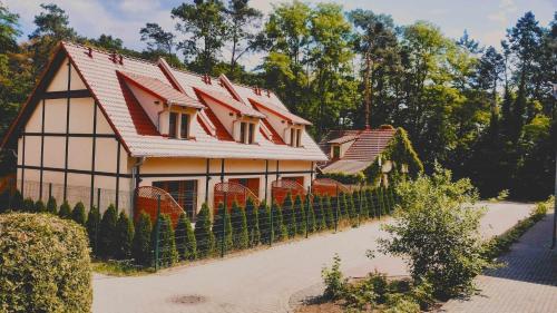 szereg domów z czerwonymi dachami w obiekcie Leśne Wzgórze przy Zamkowej w Lubniewicach