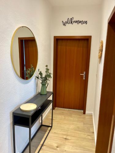 a bathroom with a sink and a mirror and a door at Perfekt für 5 - Stylisch & Zentral - Küche in Essen
