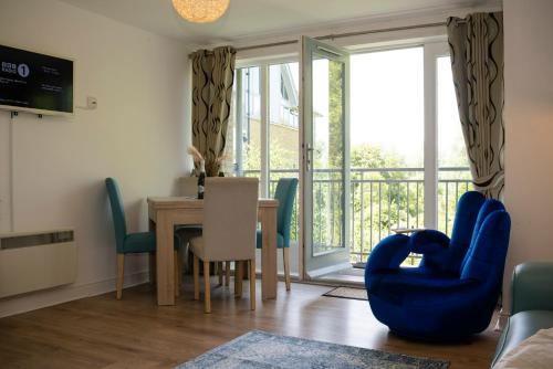 a dining room with a table and chairs and a window at Spacious 3 bedroom apartment free parking in Kent