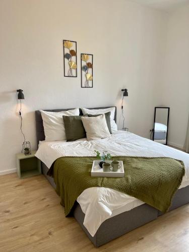 a bedroom with a large bed with a tray on it at Perfekt für 5 - Stylisch & Zentral - Küche in Essen