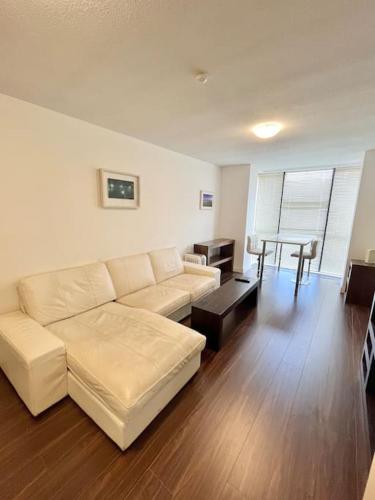 a living room with a white couch and a table at Quiet, Luxury Apt in Dublin. in Dublin