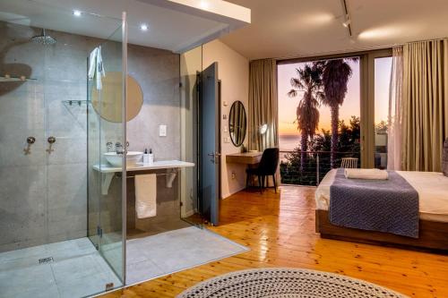 a bedroom with a shower and a bed and a bathroom at Lobster Villa in Cape Town
