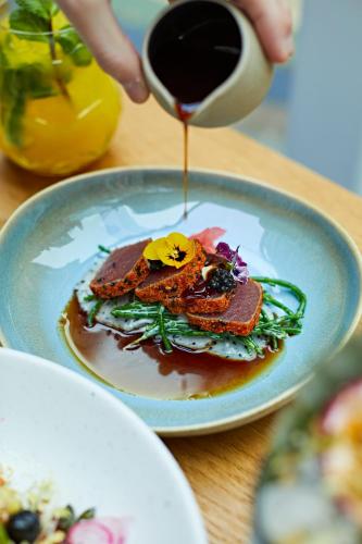 a plate of food on a table with a cup of coffee at Taj 51 Buckingham Gate Suites and Residences in London