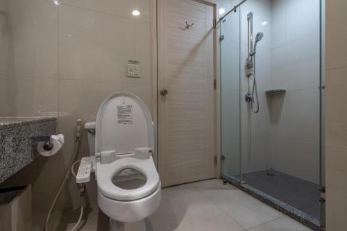 a bathroom with a toilet and a glass shower at Kantary Bay Hotel And Serviced Apartments Sriracha in Si Racha