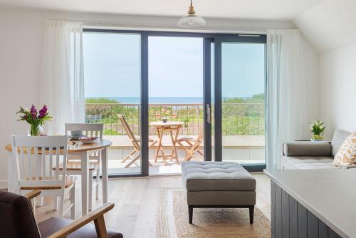 a kitchen and living room with a view of the ocean at Apartment 14, Withie Cove in Hope Cove