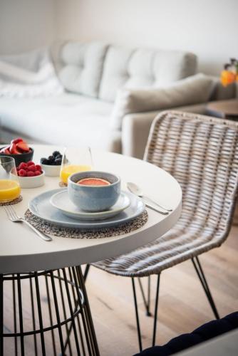 a table with a plate of food on it at Apartment 8, Forest Cove in Hope-Cove