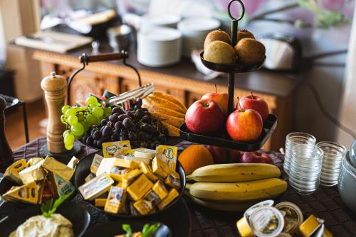 a table with a bunch of food on it at Hotel Faaker See Inn by S4Y in Faak am See