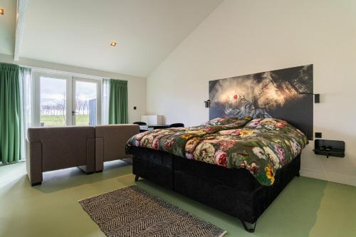 a bedroom with a king sized bed with a painting on the wall at Huize Leeghwater in Zuidoostbeemster