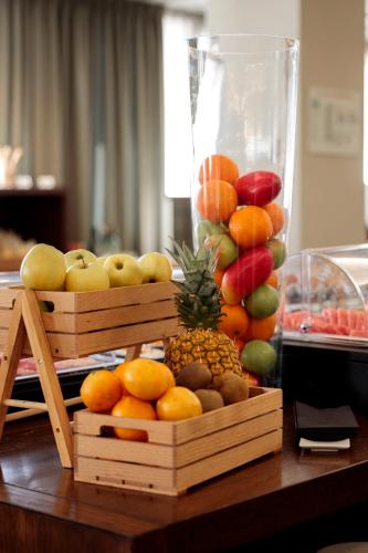 a display of fruit in wooden boxes on a table at Hotel Pax Guadalajara in Guadalajara