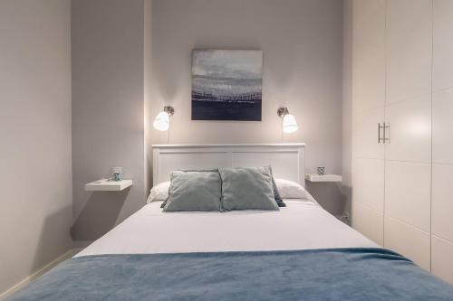 a bedroom with a bed with two pillows on it at Castellana Suites in Madrid