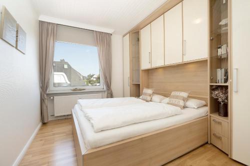 Un dormitorio con una cama grande y una ventana en Haffkamp 14, en Grömitz