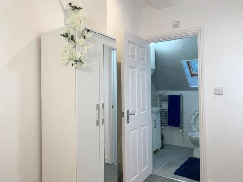 a bathroom with a white door and a toilet at Kunda House Selly Oak in Birmingham