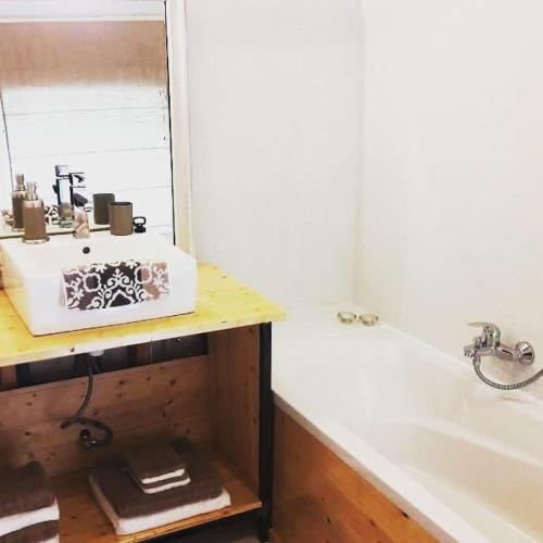 a bathroom with a sink and a bath tub at Maison-indi in Houffalize