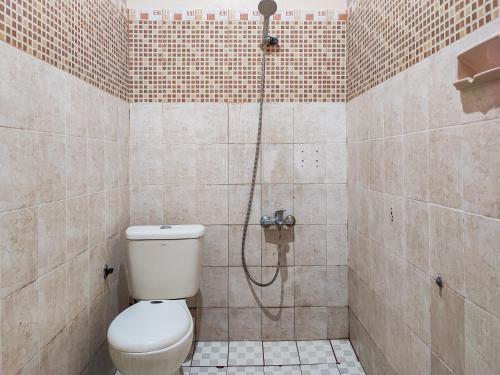 a bathroom with a shower with a toilet in it at Reddoorz Syariah Near Kantor Gubernur Jambi in Jambi