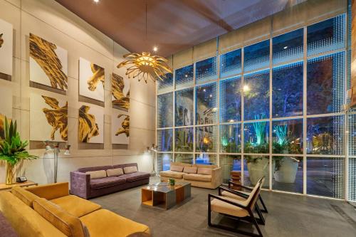 a large living room with a large window at City Express Plus by Marriott Ciudad de México Reforma El Ángel in Mexico City