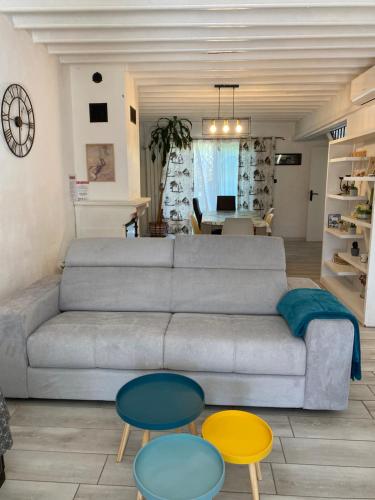 a living room with a couch and three tables at Les Micocouliers - Spacieuse maison,4chambres ,avec Jardin- Parking -Wifi in Béziers