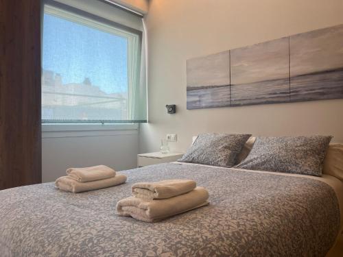 a bedroom with a bed with two towels on it at Penthouse Mentidero Loft Grupo AC Gestión in Cádiz