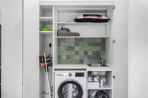 a laundry room with a washer and a washing machine at WILL56 - Gumtree Studio in Perth