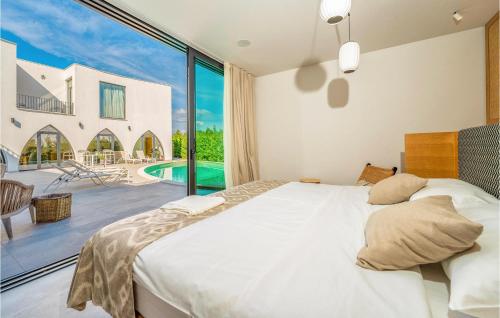 ein Schlafzimmer mit einem Bett und einem großen Fenster in der Unterkunft Cozy Home In Srima With Kitchen in Srima