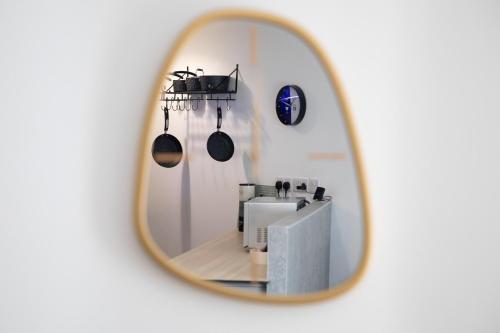a mirror reflection of a kitchen with pots and pans at Exquisite flat in Sheffield in Sheffield