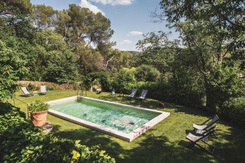 a swimming pool in the yard of a house at Les Lodges Sainte-Victoire Hotel & Spa in Aix-en-Provence