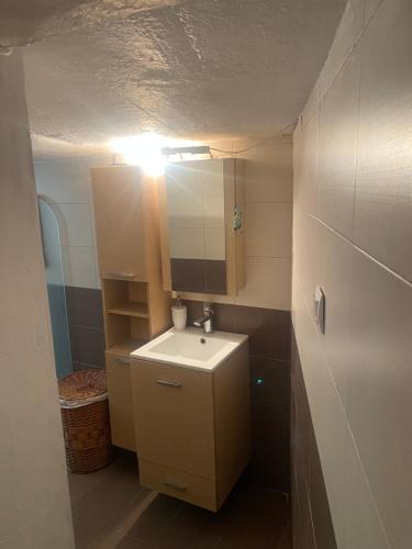 a small bathroom with a sink and a mirror at Eva's house in Mythimna