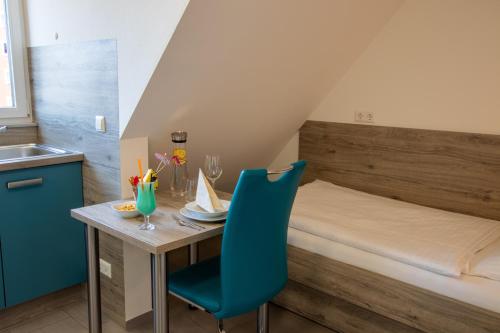 a small room with a table and a bed at hochwertiges Studio in bester Lage in Friedrichshafen