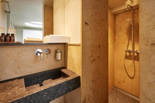 a bathroom with a sink and a shower in a room at Business Guesthouse in Groningen