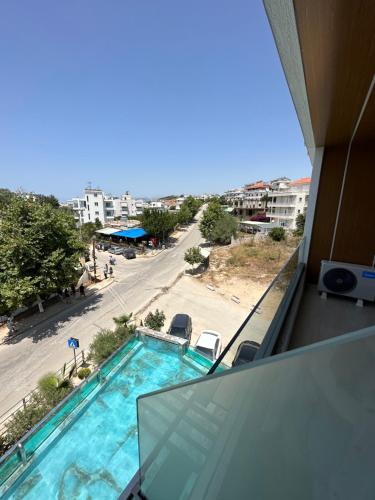 a view of a swimming pool from the balcony of a building at Ilio Boutique Hotel in Ksamil