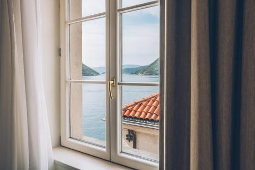 an open window with a view of the water at Heritage Grand Perast By Rixos in Perast