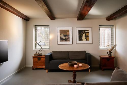 a living room with a couch and a table at Business Guesthouse in Groningen