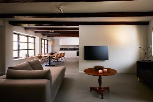 a living room with a couch and a table at Business Guesthouse in Groningen