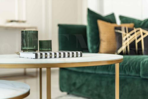 a coffee table in a living room with a green couch at Deluxe Apartment - Historic Center by REMS in Málaga
