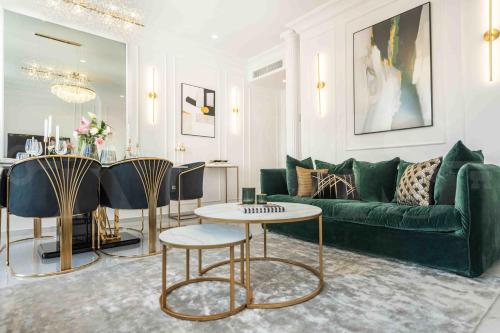 a living room with a green couch and a table at Deluxe Apartment - Historic Center by REMS in Málaga