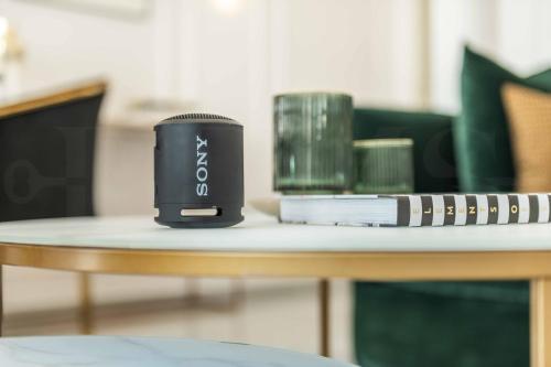 a black cup sitting on top of a table at Deluxe Apartment - Historic Center by REMS in Málaga