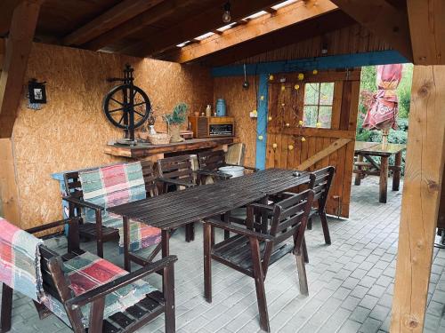 a wooden table and chairs on a patio at Chata Polovica Terchová in Terchová