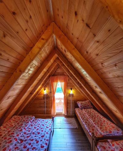 a room with two beds in a wooden attic at Nika in Nova Varoš