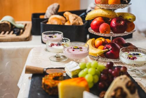 a table topped with lots of different types of fruit at Hotel Kärntnerhof Velden by S4Y in Velden am Wörthersee