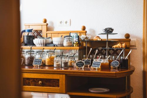 a shelf with jars and other items on it at Hotel Kärntnerhof Velden by S4Y in Velden am Wörthersee